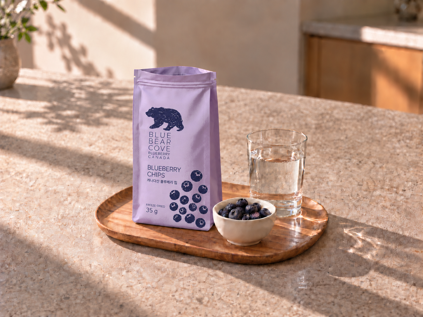 A 35g pouch with dry whole freeze-dried blueberries and a glass